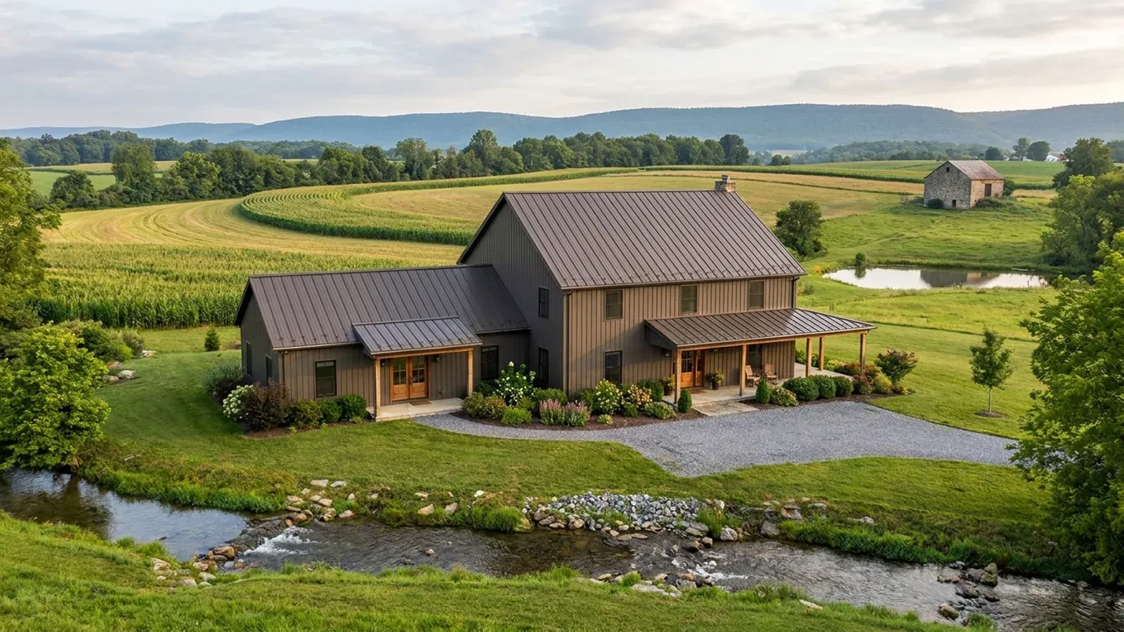 A barndominium with a smaller attached in-law suite wing that has its own separate covered entry, distinct from the main entry.