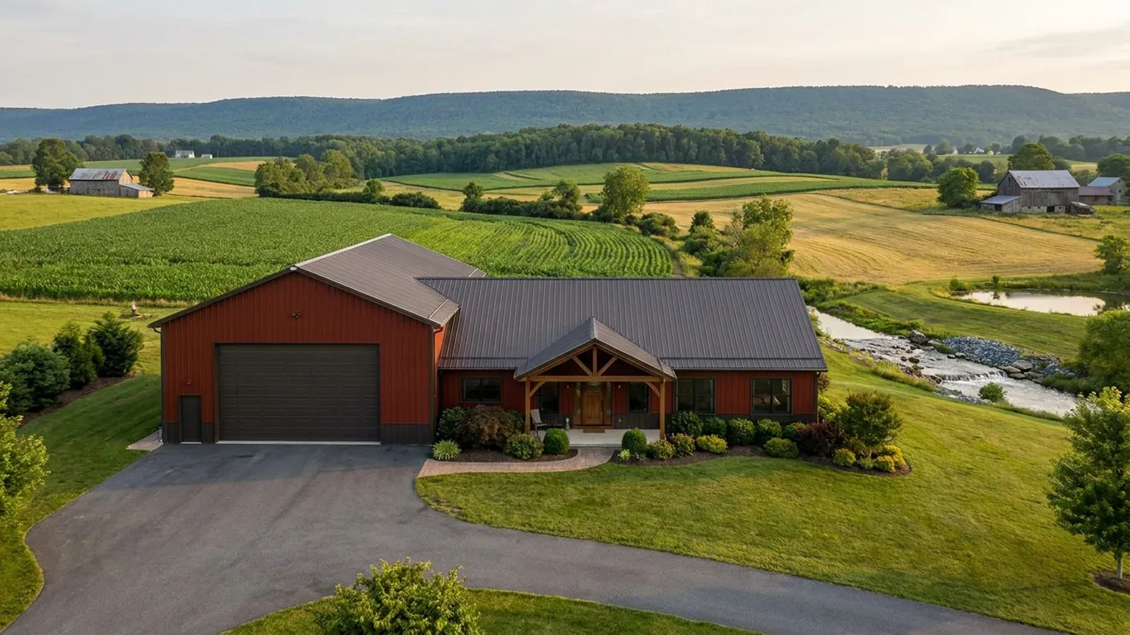 A barndominium with a tall, deep RV garage bay attached to the residence under one continuous roof.